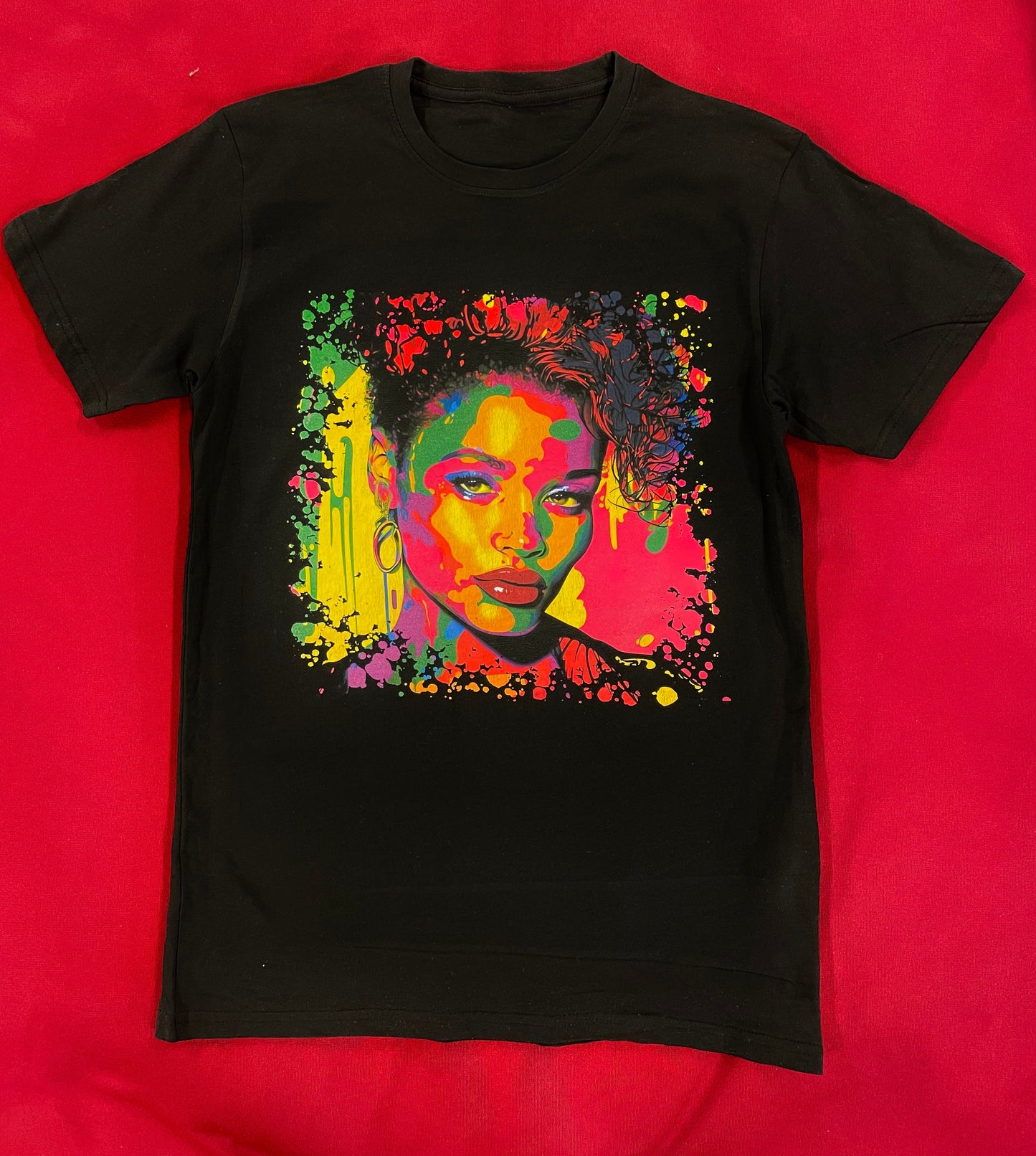 Unisex cotton t-shirt with 90s-inspired pop art print in bold colors and graphic shapes. The shirt features short sleeves and a crew neck, and is shown on a model in a casual, laid-back setting.